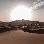 Sun rides over rolling sand
