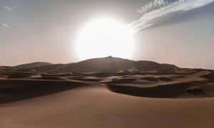 Sun rides over rolling sand