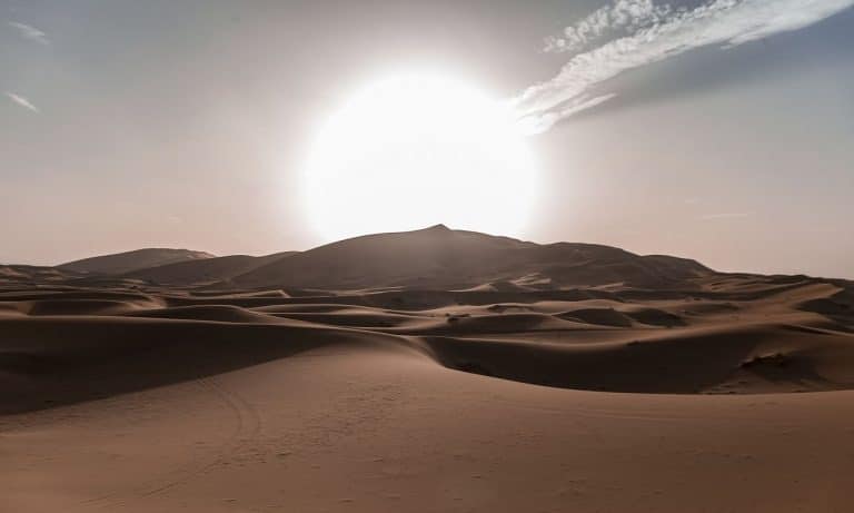 Sun rides over rolling sand